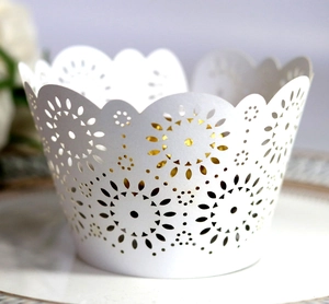 Detailed laser-cut sunflower pattern on white pearlescent paper cupcake wrapper