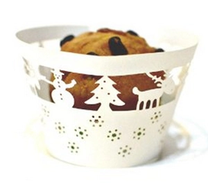 White laser-cut cupcake wrappers featuring Christmas tree and reindeer silhouettes