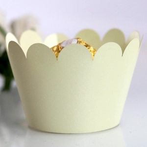 Detail of cream petal-edged cupcake wrapper with subtle glitter finish for dessert decor