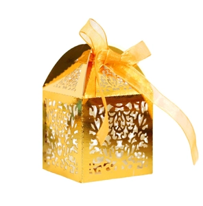 Elegant gold laser-cut hollow gift box with orange ribbon for wedding favors and candies
