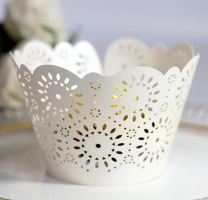 Detailed laser-cut ivory floral paper cupcake wrappers with elegant scalloped edge design