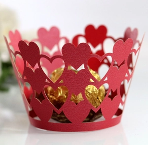 Macro view of laser-cut red heart lace paper wrapper for cupcake or candy gift
