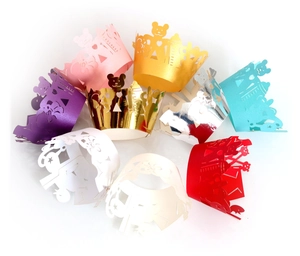 Colorful laser-cut paper cake wrappers with bear and heart patterns for party decoration