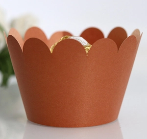 Detailed view of a brown laser-cut cupcake liner with elegant scalloped petal edges