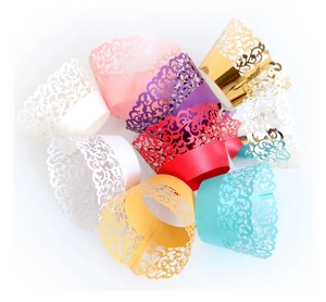 Laser cut hollow cupcake liners in assorted metallic colors featuring elegant patterns