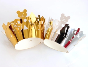 Laser-cut crown cupcake wrappers with bear patterns in metallic gold and silver finish