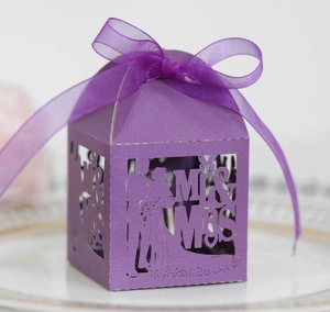 Detail of laser-cut purple wedding candy box with Mr & Mrs silhouette and organza ribbon