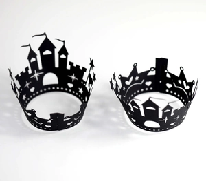 Detail of laser-cut black Halloween cupcake wrappers with castle and star silhouettes