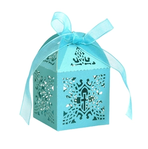 Detail of light blue laser-cut paper gift box with cross pattern and ribbon for weddings