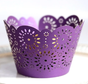 Elegant purple laser cut floral cupcake liners with intricate decorative paper patterns