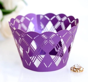 Detail of laser-cut purple cupcake wrappers with hollow geometric patterns for parties