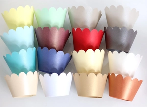 Macro shot showing 16 vibrant pearlescent cupcake wrappers with wave edges for baking decor