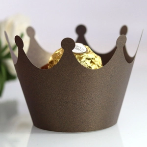 Detailed macro view of dark brown crown-shaped laser-cut cupcake liners for party desserts