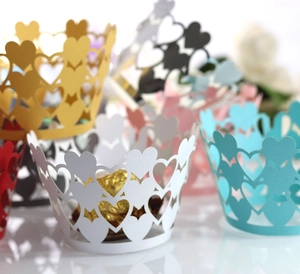 Detailed laser-cut heart patterns on assorted color cupcake wrappers for parties