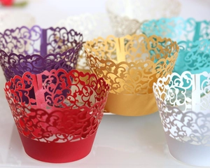 Laser cut hollow cupcake wrappers in multiple vibrant colors for party decorations