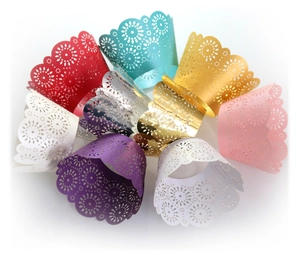 Detailed macro view of laser-cut floral cupcake wrappers in multiple vibrant colors
