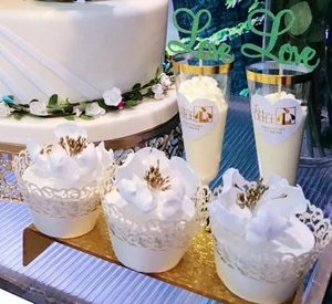 Detailed laser-cut white lace cupcake wrappers with elegant floral pattern for weddings