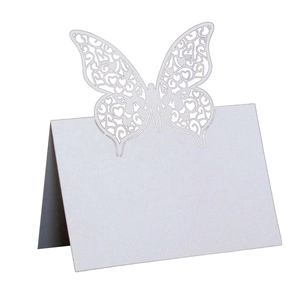 Detail of white butterfly laser-cut tent card for wedding table seating arrangements