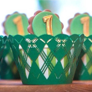 Detail showing dark green laser-cut cupcake wrapper with intricate diamond pattern