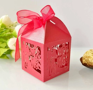 Laser cut red wedding favor box featuring Mr & Mrs silhouette and red organza ribbon