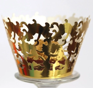 Golden laser-cut lace cupcake wrappers with elegant hollow vine pattern for party decor