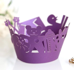 Detailed laser-cut purple cupcake wrapper featuring bear and bottle patterns