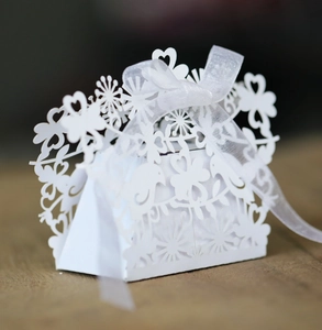 Detailed laser-cut heart and bird patterns on white paper wedding favor candy box