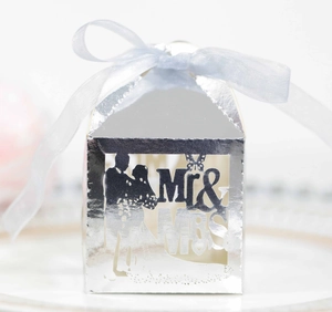 Detail of silver laser-cut wedding candy box with Mr & Mrs silhouette and blue ribbon