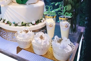 Detail of white laser cut lace cupcake wrappers with elegant floral cupcake decorations