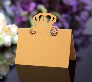 Laser-cut gold wedding table card featuring romantic horse carriage and couple silhouette