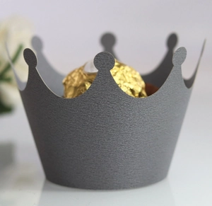 Macro shot of laser-cut crown cake wrapper with glitter texture for elegant desserts