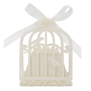 Detail of laser-cut birdcage candy box in cream white with a sheer ribbon bow