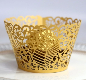 Detailed laser-cut cupcake wrapper with elegant gold vine and leaf patterns