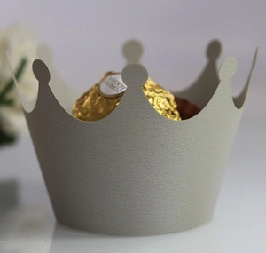 Close-up of hollow crown lace paper wrapper in light grey for gift chocolate balls