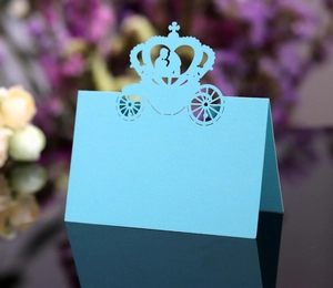 Detail of sky blue laser cut carriage place cards with elegant couple silhouette