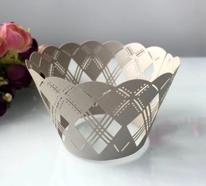 Macro detail of laser-cut cupcake wrapper with geometric patterns and scalloped edges