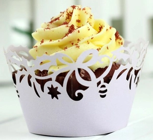 Detail showing white laser-cut hollow star lace cupcake wrapper on red velvet cake