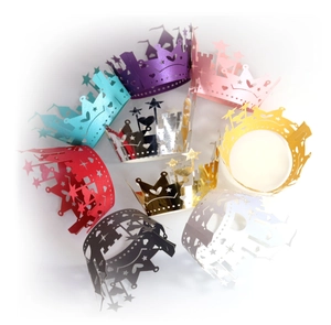 Detail of laser-cut crown and castle cupcake wrappers in various metallic colors