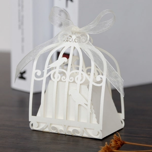 Detailed laser-cut birdcage wedding favor box in ivory pearl paper with ribbon tie