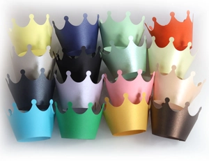 Macro display of 16 multicolor paper cupcake crown toppers for birthday party favors