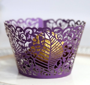 Deep purple laser cut cupcake wrapper with intricate vine leaves and floral patterns