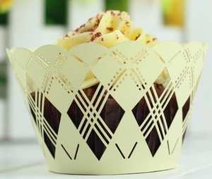 Macro view of light yellow laser-cut cupcake wrapper with hollow diamond pattern detail