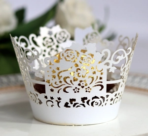 Elegant white laser-cut rose cupcake wrappers with golden liners for wedding party decor