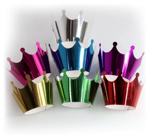 Close-up of shiny metallic party crowns in seven colors including gold and silver