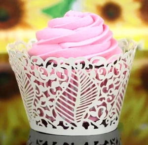 Laser cut vine leaf cupcake wrappers in pearlescent white for wedding cake decoration