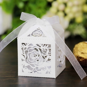 Laser-cut white paper gift box with rose patterns and a delicate organza ribbon bow