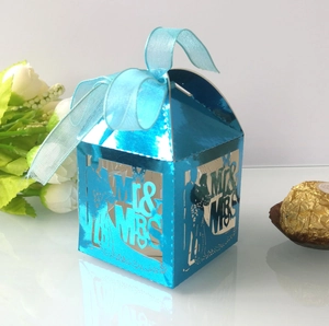 Detail of laser-cut Mr & Mrs blue wedding candy box with elegant ribbon and mirror finish
