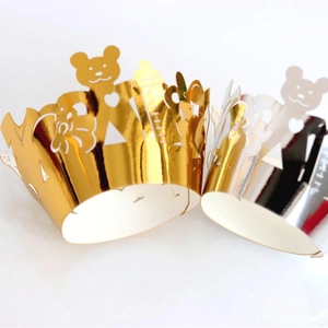 Hollow laser cut cupcake liners featuring bear and heart patterns in gold and silver