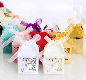 Detailed laser-cut Mr & Mrs wedding favor boxes with satin ribbons in multiple colors