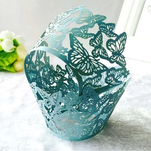 Laser-cut butterfly cupcake wrappers in elegant grey-green for party table decorations